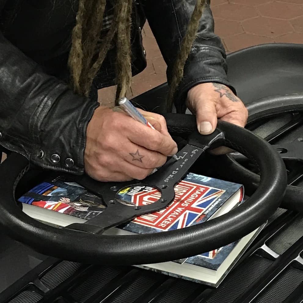 Magnus Walker signing a steering wheel for PATIPATINA